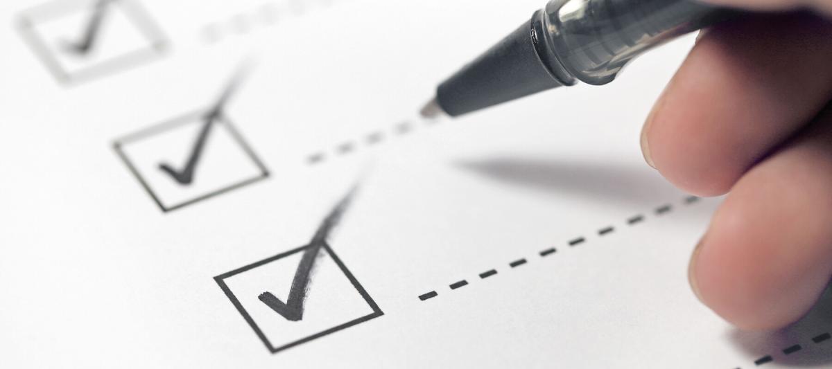 black pen marking a checklist