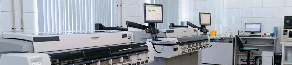 an office with multiple large multi-function printers