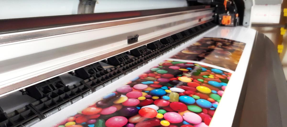 Wide format printer printing on glossy paper for advertising,